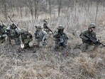 US soldiers (L) and South Korean soldiers (R) participate in a South Korea-US joint drill at a military training field in the border city of Paju as part of the Freedom Shield joint military exercise.