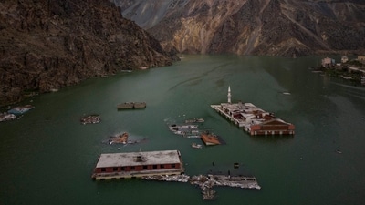An aerial view of buildings and the top of a minaret in the rising water of an artificial lake that gradually submerged the village of Yusufeli on April 5. The Yusufeli Dam and Hydroelectric Power Plant started to be built on the Çoruh River in 2013. (Yasin Akgul / AFP) An aerial view of buildings and the top of a minaret in the rising water of an artificial lake that gradually submerged the village of Yusufeli on April 5. The Yusufeli Dam and Hydroelectric Power Plant started to be built on the Çoruh River in 2013. (Yasin Akgul / AFP)