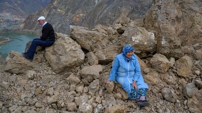 Local residents look on at their town submerged by an artificial lake caused by the dam. (Yasin Akgul / AFP) Local residents look on at their town submerged by an artificial lake caused by the dam. (Yasin Akgul / AFP)