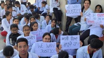 AIIMS Bathinda doctors holding up placards during their strike to protest against arrest of one of a colleagues. (HT Photo)