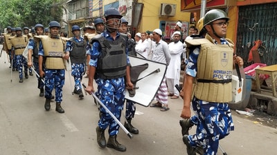 Rapid Action Force (RAF) personnel patrol the area following the violence that broke out during the Ram Navami procession, in Howrah on Friday. (ANI Photo)