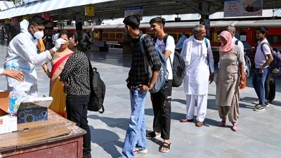 A healthcare worker collects a nasal swab sample of a passenger for COVID-19 testing amid a recent surge in the Coronavirus case, at the Railway Station, in Bikaner on Wednesday. (ANI) A healthcare worker collects a nasal swab sample of a passenger for COVID-19 testing amid a recent surge in the Coronavirus case, at the Railway Station, in Bikaner on Wednesday. (ANI)