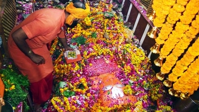 A priest offers sweets on the occasion of Hanuman Jayanti at Bade Hanuman Ji temple, in Prayagraj on Thursday. (ANI) A priest offers sweets on the occasion of Hanuman Jayanti at Bade Hanuman Ji temple, in Prayagraj on Thursday. (ANI)
