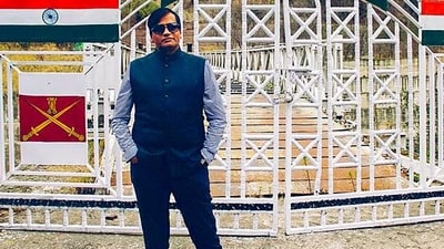 An undated photo of Kiran Patel with a security man. Patel has been arrested for cheating, forgery and impersonation. (PTI file)