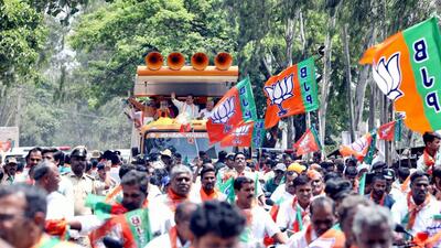 BJP National President JP Nadda (C), former Karnataka CM BS Yediyurappa (R) and Karnataka party President Nalin Kumar Kateel during a roadshow at Tiptur/ (PTI) BJP National President JP Nadda (C), former Karnataka CM BS Yediyurappa (R) and Karnataka party President Nalin Kumar Kateel during a roadshow at Tiptur/ (PTI)