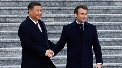 Chinese President Xi Jinping shakes hands with French President Emmanuel Macron at the Great Hall of the People, in Beijing, China, April 6, 2023. (Reuters)