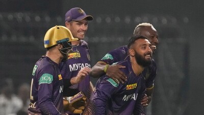 Kolkata Knight Riders' Varun Chakravarthy celebrates after taking a catch to dismiss Royal Challengers Bangalore's Akash Deep. (AP) Kolkata Knight Riders' Varun Chakravarthy celebrates after taking a catch to dismiss Royal Challengers Bangalore's Akash Deep. (AP)