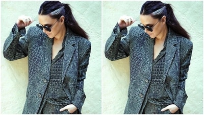 Neha looked gorgeous in the monochrome printed georgette long shirt featuring buttoned-up details till the waist, a plunging neckline, and open shrug patterns below. She teamed it with a matching pair of satin trousers and a blazer featuring the same print.&nbsp; (Instagram/@nehadhupia)
