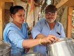 Anita Sachdeva (left) helping Pradeep Sachdeva (right) prepare an order of rajma chawal. Anita Sachdeva (left) helping Pradeep Sachdeva (right) prepare an order of rajma chawal.