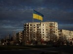 A Ukrainian national flag flutters near the buildings destroyed by Russian military strike, amid Russia's invasion of Ukraine, in the town of Borodianka, in Kyiv.