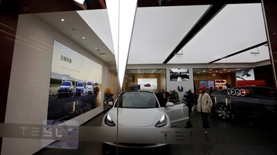 Visitors check a Tesla Model 3 car next to a Model Y displayed at a showroom of the U.S. electric vehicle (EV) maker in Beijing, China February 4, 2023. REUTERS/Florence Lo (REUTERS)