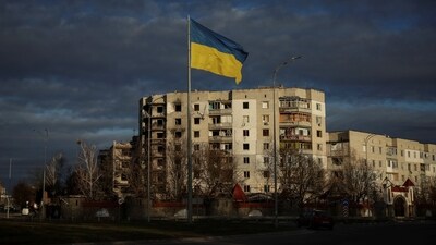 A Ukrainian national flag flutters near the buildings destroyed by Russian military strike, amid Russia's invasion of Ukraine, in the town of Borodianka, in Kyiv. (Reuters)
