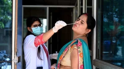 A health worker collects a swab sample for Covid-19 test at the District Hospital in Sector 30, in Noida, on Thursday. (HT_PRINT) A health worker collects a swab sample for Covid-19 test at the District Hospital in Sector 30, in Noida, on Thursday. (HT_PRINT)