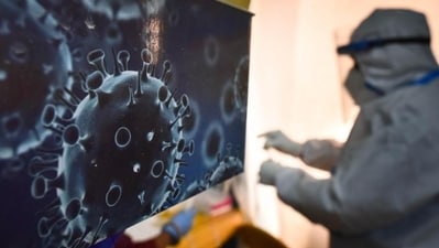An illustration of the novel coronavirus seen next to a health care worker at a Covid-19 testing centre. (Sanchit Khanna / HT Photo) An illustration of the novel coronavirus seen next to a health care worker at a Covid-19 testing centre. (Sanchit Khanna / HT Photo)