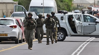 Israeli forces and emergency personnel gather near the Hamra junction, in the northern part of the Jordan valley in the occupied West Bank, following a shooting attack on Friday. (AFP) Israeli forces and emergency personnel gather near the Hamra junction, in the northern part of the Jordan valley in the occupied West Bank, following a shooting attack on Friday. (AFP)