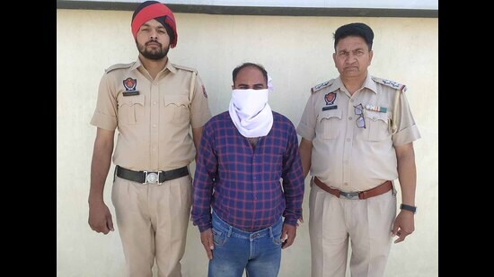 Accused of smuggling intoxicant pills in custody of STF in Ludhiana on Friday. (HT Photo)