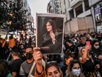 A protester holds a portrait of Mahsa Amini  during a demonstration in support of Amini, a young Iranian woman who died after being arrested in Tehran by the Islamic Republic's morality police, on Istiklal avenue in Istanbul. 