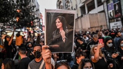 A protester holds a portrait of Mahsa Amini during a demonstration in support of Amini, a young Iranian woman who died after being arrested in Tehran by the Islamic Republic's morality police, on Istiklal avenue in Istanbul. (AFP file) A protester holds a portrait of Mahsa Amini during a demonstration in support of Amini, a young Iranian woman who died after being arrested in Tehran by the Islamic Republic's morality police, on Istiklal avenue in Istanbul. (AFP file)