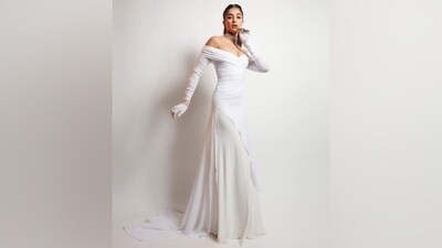 Pooja styled the gown with matching full-length ivory Opera gloves. She picked an ivory and silver choker necklace, matching stacked bracelets, a statement ring, and white strappy killer high heels to accessorise the Princess-esque gown. (Instagram) Pooja styled the gown with matching full-length ivory Opera gloves. She picked an ivory and silver choker necklace, matching stacked bracelets, a statement ring, and white strappy killer high heels to accessorise the Princess-esque gown. (Instagram)