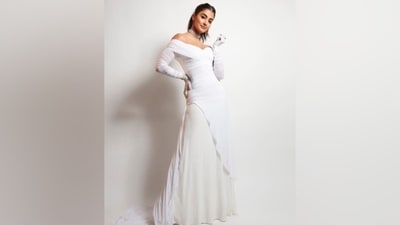 Pooja's ivory gown features an off-the-shoulder plunging neckline highlighting her décolletage, a gathered design on the front, a flowy skirt, a floor-sweeping train on the back, and a figure-hugging silhouette accentuating her enviable svelte frame. (Instagram) Pooja's ivory gown features an off-the-shoulder plunging neckline highlighting her décolletage, a gathered design on the front, a flowy skirt, a floor-sweeping train on the back, and a figure-hugging silhouette accentuating her enviable svelte frame. (Instagram)