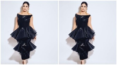 Her stunning outfit is from the shelves of fashion label BLONI. Her dress boasts a black leather silhouette, a sleek straight neckline, and layered frills made of delicate netting, giving the dress an ethereal touch. (Instagram/@bhumipednekar) Her stunning outfit is from the shelves of fashion label BLONI. Her dress boasts a black leather silhouette, a sleek straight neckline, and layered frills made of delicate netting, giving the dress an ethereal touch. (Instagram/@bhumipednekar)