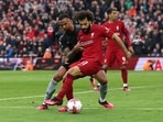 Liverpool's Mohamed Salah in action with Arsenal's Gabriel