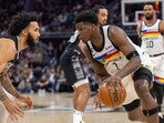 Minnesota Timberwolves guard Anthony Edwards (1) looks to drive past San Antonio Spurs forward Julian Champagnie, left, during the first half of an NBA basketball game, Saturday, April 8, 2023, in Austin, Texas. Minnesota Timberwolves guard Anthony Edwards (1) looks to drive past San Antonio Spurs forward Julian Champagnie, left, during the first half of an NBA basketball game, Saturday, April 8, 2023, in Austin, Texas.