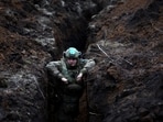 Russia-Ukraine War: A Ukrainian serviceman hides in a trench near the frontline town of Bakhmut amid Russia's attack on Ukraine, Donetsk region.