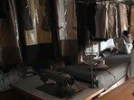 A tailor sits at his shop in a market during a nationwide power outage in Pakistan's Rawalpindi. A tailor sits at his shop in a market during a nationwide power outage in Pakistan's Rawalpindi.