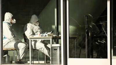 Covid In China: Security guards wearing personal protective equipment (PPE) amid the Covid-19 pandemic sit at an entrance of a building in Beijing. (AFP) Covid In China: Security guards wearing personal protective equipment (PPE) amid the Covid-19 pandemic sit at an entrance of a building in Beijing. (AFP)