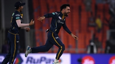 Gujarat Titans' Rashid Khan (R) celebrates after taking the wicket of Kolkata Knight Riders' Shardul Thakur (AFP) Gujarat Titans' Rashid Khan (R) celebrates after taking the wicket of Kolkata Knight Riders' Shardul Thakur (AFP)