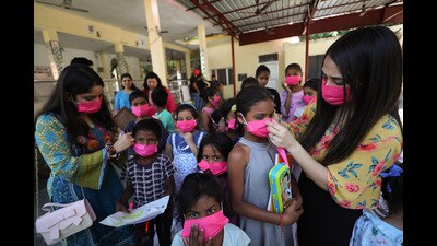 College students and NGO members distribute masks among children at a programme in a slum, in Jammu, on Sunday. Twenty patients recovered, prompting the active Covid cases to reach 392 of which 250 of them are in Kashmir and 142 in Jammu division. (PTI) College students and NGO members distribute masks among children at a programme in a slum, in Jammu, on Sunday. Twenty patients recovered, prompting the active Covid cases to reach 392 of which 250 of them are in Kashmir and 142 in Jammu division. (PTI)