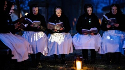 Women wearing the traditional dress of the Slavic minority of the Sorbs sing in front of the church on early Easter Sunday in Schleife, eastern Germany. (AFP)