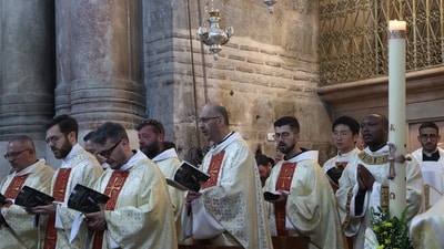 Clergy men attend a mass on Easter Sunday at the Church of the Holy Sepulchre in Jerusalem. (AFP)