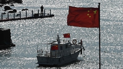 A man stands on a jetty behind a tourist boat and Chinese flags on Pingtan island, opposite Taiwan, in China�s southeast Fujian province on Sunday. (AFP) A man stands on a jetty behind a tourist boat and Chinese flags on Pingtan island, opposite Taiwan, in China�s southeast Fujian province on Sunday. (AFP)