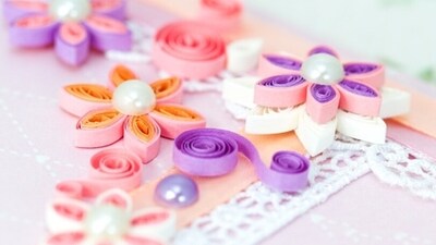 Experiment with different paper types and sizes: Paper quilling involves using thin strips of paper to create intricate designs and patterns. To become an expert, you should experiment with different types of paper, including various colors, textures, and weights. Try using different sizes of paper strips as well, as this can create different effects. (Unsplash)