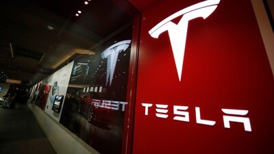 A sign bearing the Tesla company logo is displayed outside a Tesla store. (AP)