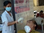 A healthcare worker collects a nasal swab sample of a person for COVID-19 testing in view of the rising Coronavirus cases. A healthcare worker collects a nasal swab sample of a person for COVID-19 testing in view of the rising Coronavirus cases.