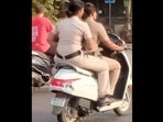 Mumbai cops riding on a scooty without helmets. 