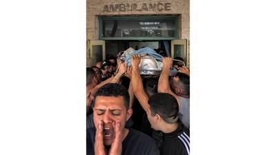 Mourners carry the body of Palestinian teenager Mohamed Fayez Balhan, a 15 year-old boy, out of a morgue in Jericho situated in the occupied West Bank on April 10, He was killed during a Israeli raid on the Aqabat Jaber camp. Palestinian health officials have reported the start of 2023 to be the most deadly for Palestinians in at least two decades, reported AP. (Ahmad Gharabli / AFP) Mourners carry the body of Palestinian teenager Mohamed Fayez Balhan, a 15 year-old boy, out of a morgue in Jericho situated in the occupied West Bank on April 10, He was killed during a Israeli raid on the Aqabat Jaber camp. Palestinian health officials have reported the start of 2023 to be the most deadly for Palestinians in at least two decades, reported AP. (Ahmad Gharabli / AFP)