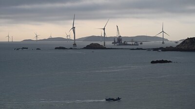 A fishing boat sails past wind turbines north of Pingtan island, opposite Taiwan, in China. (AFP) A fishing boat sails past wind turbines north of Pingtan island, opposite Taiwan, in China. (AFP)