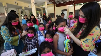 College students and NGO members distribute masks among children at a programme in a slum, in Jammu, on Sunday. (PTI) College students and NGO members distribute masks among children at a programme in a slum, in Jammu, on Sunday. (PTI)