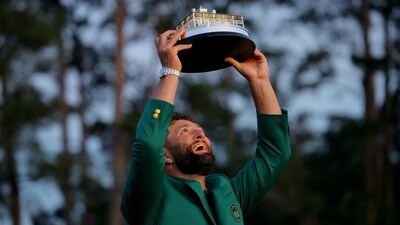 Spain's Jon Rahm celebrates with his green jacket and the trophy after winning The Masters. (REUTERS)