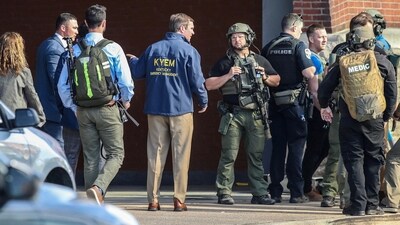 Kentucky Governor Andy Beshear speaks with police deploying at the scene of a mass shooting near Slugger Field baseball stadium in downtown Louisville. (via REUTERS)