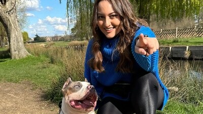 Sonakshi Sinha, in the photos, posed with a dog as she spent her time in a park. She smiled and pointed at the camera as she sat down with the dog. Sonakshi Sinha, in the photos, posed with a dog as she spent her time in a park. She smiled and pointed at the camera as she sat down with the dog.