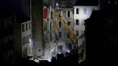 An excavator moves rubble after a building collapsed in Marseille, southern France. (AFP) An excavator moves rubble after a building collapsed in Marseille, southern France. (AFP)
