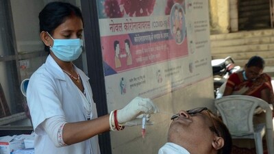 A healthcare worker collects a nasal swab sample of a person for COVID-19 testing in view of the rising Coronavirus cases. (ANI) A healthcare worker collects a nasal swab sample of a person for COVID-19 testing in view of the rising Coronavirus cases. (ANI)