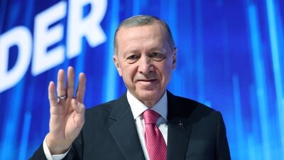 Turkish President Tayyip Erdogan greets the audience during a meeting of his ruling AK Party to announce the party's election manifesto. (via REUTERS)