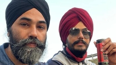 In the picture, it appears that Amritpal Singh and Papalpreet Singh are sitting atop a truck. In the picture, it appears that Amritpal Singh and Papalpreet Singh are sitting atop a truck.