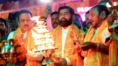 Maharashtra Chief Minister Eknath Shinde performs aarti on the banks of the Saryu River, in Ayodhya on Sunday. (ANI Photo)